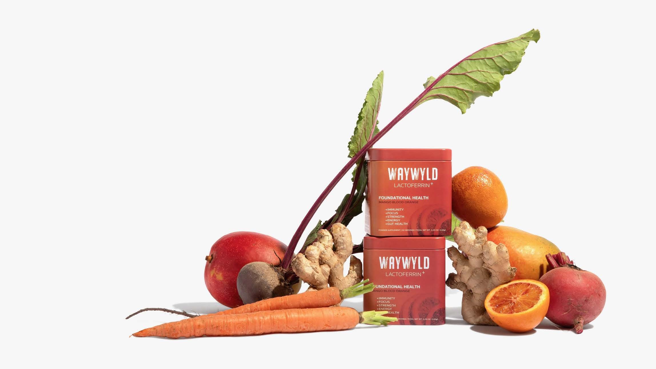 Orange WAYWYLD lactoferrin supplement jar surrounded by fresh mango and blood orange slices